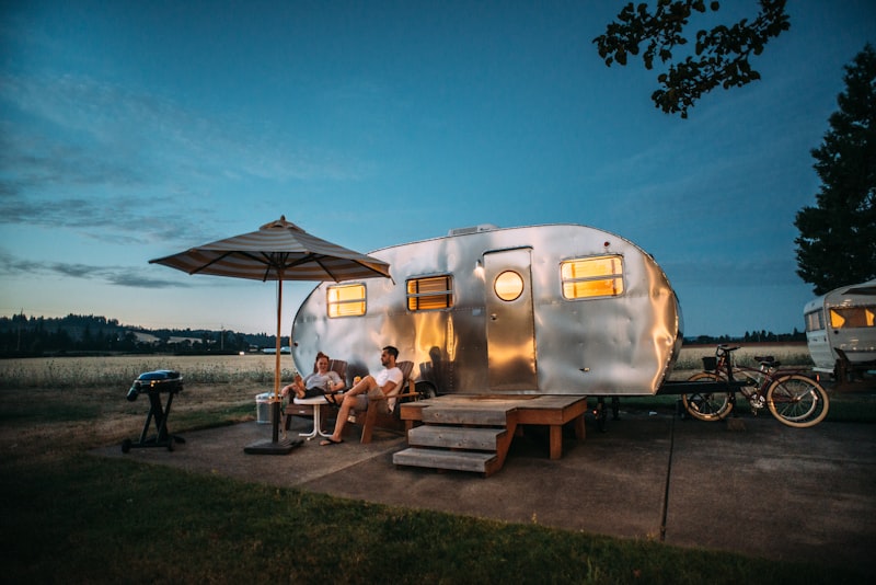 Travel trailer parked at a shady campsite